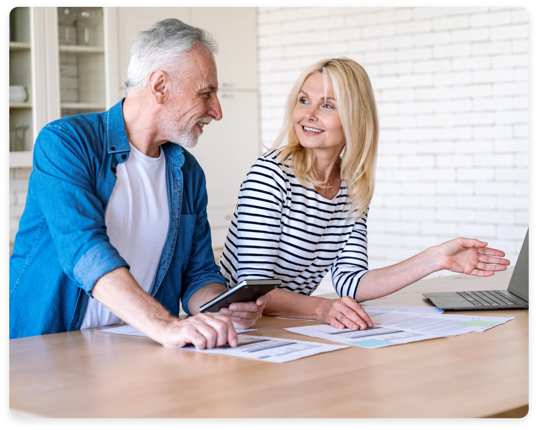 Senior partners planning with papers and laptop