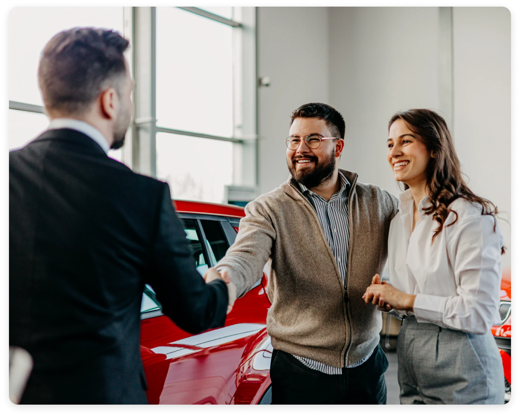 Couple buying new red car